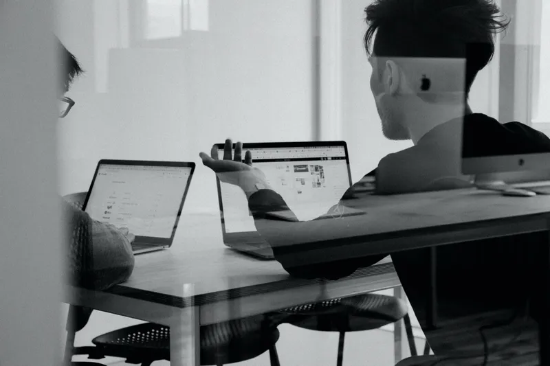 Team reviewing security work at a desk
